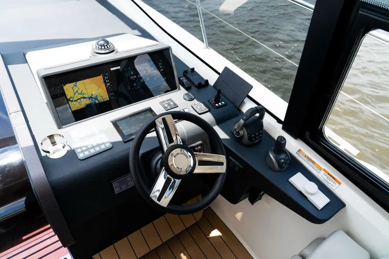  Yacht Photos Pics Helm of 2022 Bavaria SR41 yacht with navigation screens and controls.