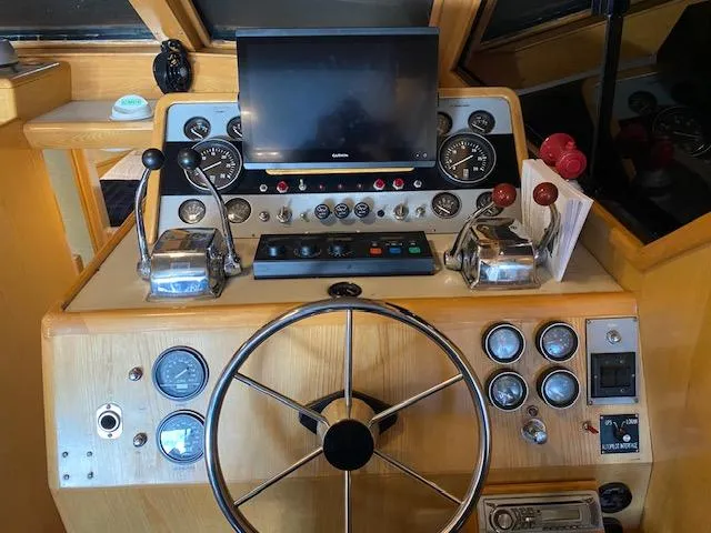  Yacht Photos Pics Control panel of a 1989 Ocean Alexander 42 yacht with steering wheel and navigation instruments.