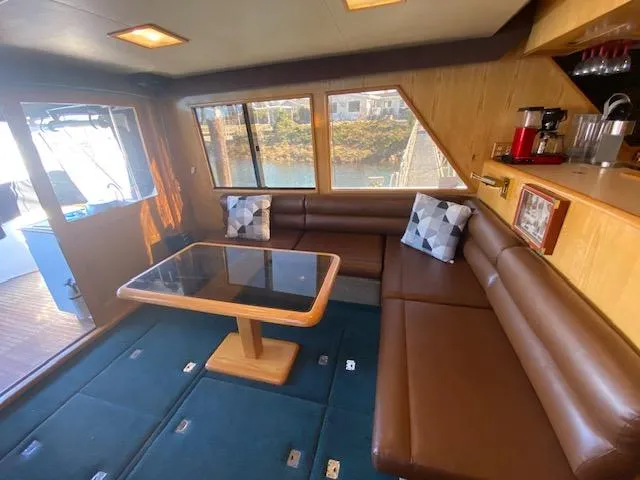  Yacht Photos Pics Interior of 1989 Ocean Alexander 42 yacht with brown seating and glass table.