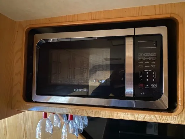  Yacht Photos Pics Microwave in 1989 Ocean Alexander 42 yacht kitchen with hanging wine glasses.