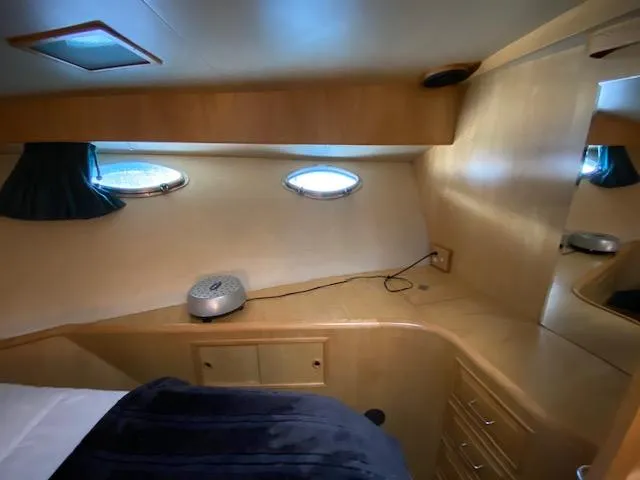  Yacht Photos Pics Interior cabin of 1989 Ocean Alexander 42 yacht with portholes and wooden cabinetry.