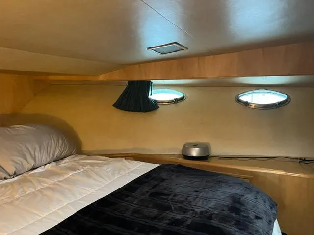  Yacht Photos Pics Cozy cabin interior of 1989 Ocean Alexander 42 yacht with porthole windows.