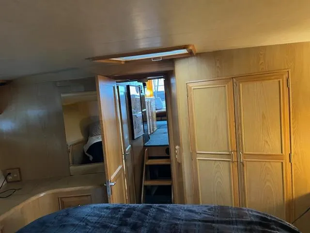  Yacht Photos Pics Interior of 1989 Ocean Alexander 42 yacht with wooden cabinetry and cozy sleeping area.