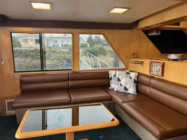 Yacht Photos Pics Interior of 1989 Ocean Alexander 42 yacht with brown leather seating and a glass-top table.