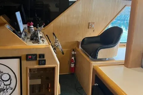  Yacht Photos Pics Interior helm of 1989 Ocean Alexander 42 yacht with steering wheel and captain's chair.