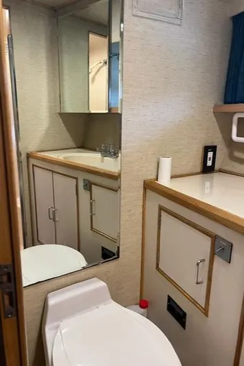  Yacht Photos Pics Bathroom interior of 1989 Ocean Alexander 42 yacht, featuring sink, mirror, and toilet.