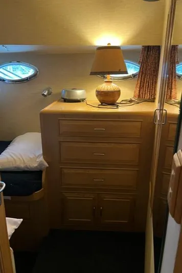  Yacht Photos Pics Cozy cabin interior of 1989 Ocean Alexander 42 yacht with wooden drawers and lamp.