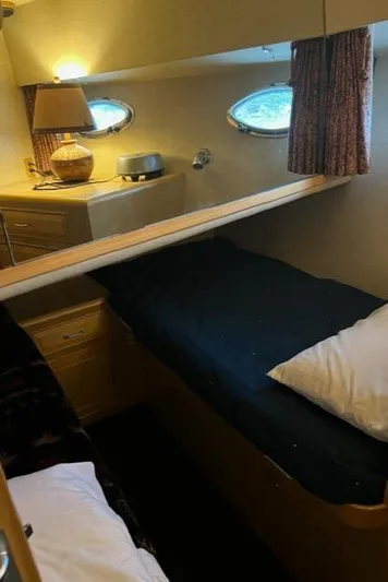  Yacht Photos Pics 1989 Ocean Alexander 42 cabin interior with cozy bed and porthole windows.