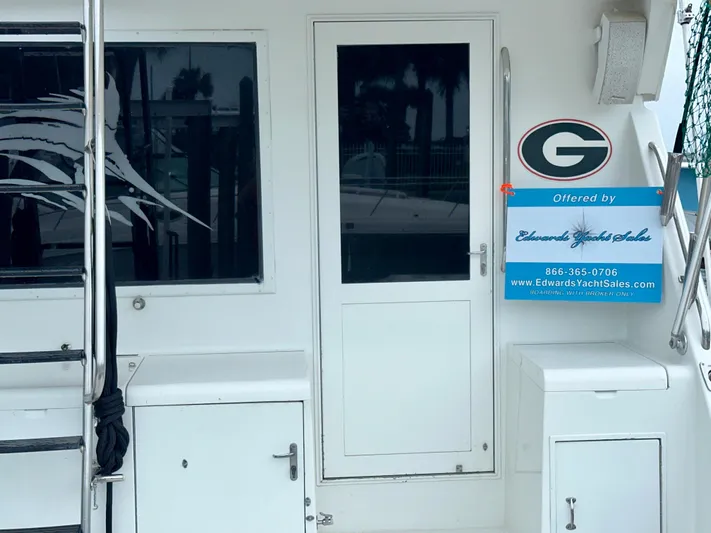 Billie Jo Yacht Photos Pics 1994 Hatteras 46 Convertible yacht with sales sign on deck.