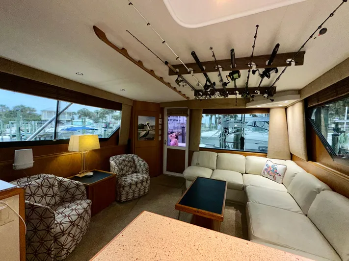 Billie Jo Yacht Photos Pics Luxurious interior of 1994 Hatteras 46 Convertible yacht with fishing rods and comfortable seating.
