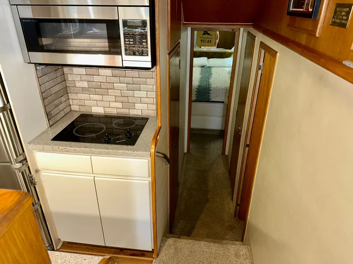 Billie Jo Yacht Photos Pics Interior of 1994 Hatteras 46 Convertible yacht with modern kitchen and hallway view.