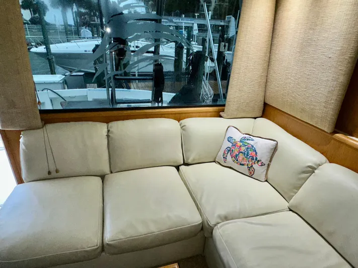 Billie Jo Yacht Photos Pics 1994 Hatteras 46 Convertible yacht interior with beige sofa and decorative pillow.