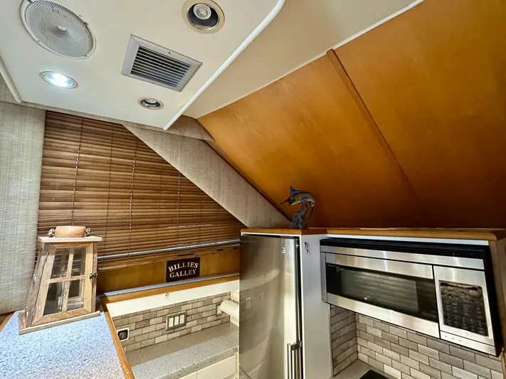 Billie Jo Yacht Photos Pics 1994 Hatteras 46 Convertible kitchen with modern appliances and wooden accents.