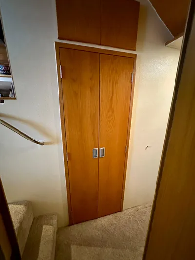 Billie Jo Yacht Photos Pics Interior of 1994 Hatteras 46 Convertible yacht with wooden doors and carpeted stairs.