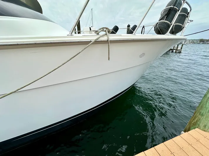 Billie Jo Yacht Photos Pics 1994 Hatteras 46 Convertible yacht docked on calm water.