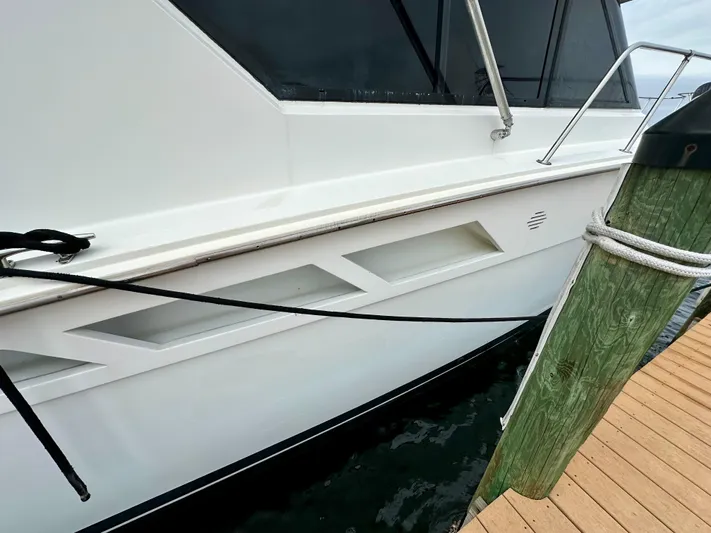 Billie Jo Yacht Photos Pics 1994 Hatteras 46 Convertible yacht docked, showcasing sleek white exterior and modern design.