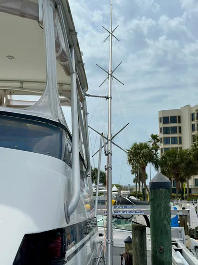 Billie Jo Yacht Photos Pics 1994 Hatteras 46 Convertible yacht docked with antenna, palm trees, and buildings in the background.