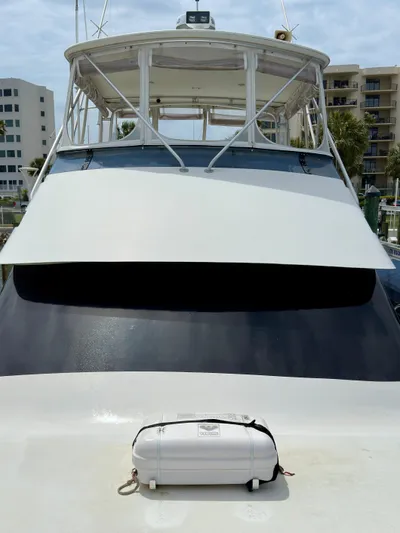 Billie Jo Yacht Photos Pics 1994 Hatteras 46 Convertible yacht docked, featuring a sleek design and spacious upper deck.