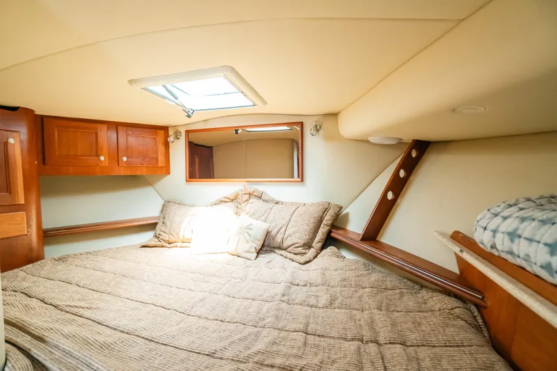  Yacht Photos Pics Cozy cabin interior of 2007 Rampage 38 Express with bed and wooden cabinetry.