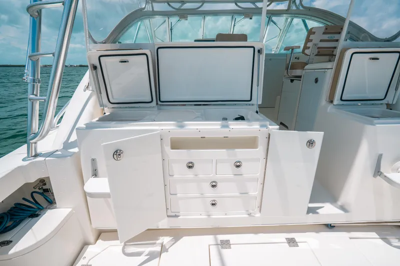  Yacht Photos Pics 2007 Rampage 38 Express boat interior with open storage compartments and drawers.