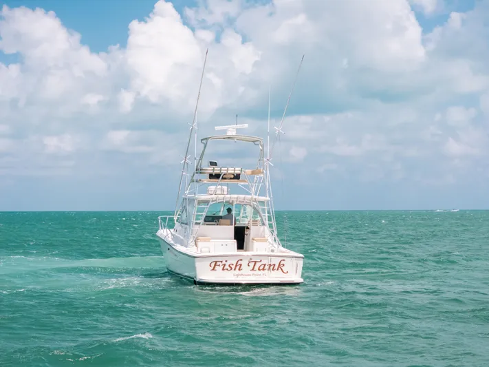  Yacht Photos Pics 2007 Rampage 38 Express boat named "Fish Tank" on open sea under cloudy sky.