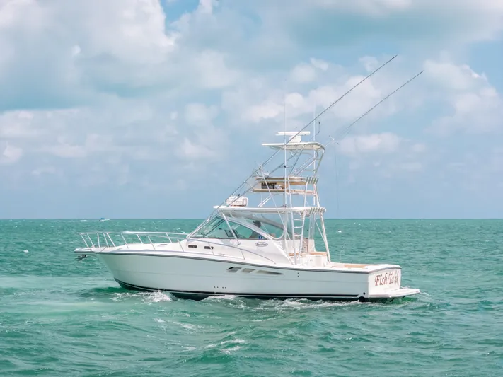  Yacht Photos Pics 2007 Rampage 38 Express boat cruising on turquoise ocean under cloudy sky.