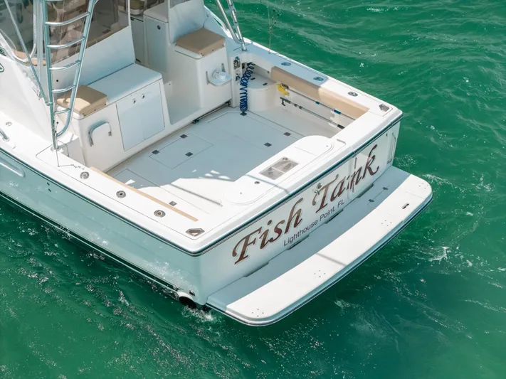  Yacht Photos Pics 2007 Rampage 38 Express boat on turquoise water, rear view.