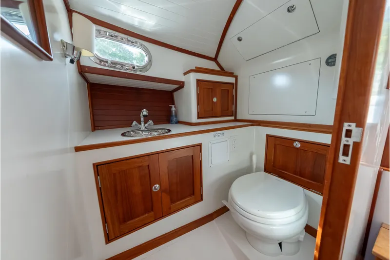 Eloise Yacht Photos Pics 2020 CH Marine Shelter Island Nomad boat bathroom with wooden cabinets and modern fixtures.