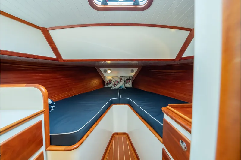 Eloise Yacht Photos Pics 2020 CH Marine Shelter Island Nomad cabin interior with wooden finish and blue bedding.