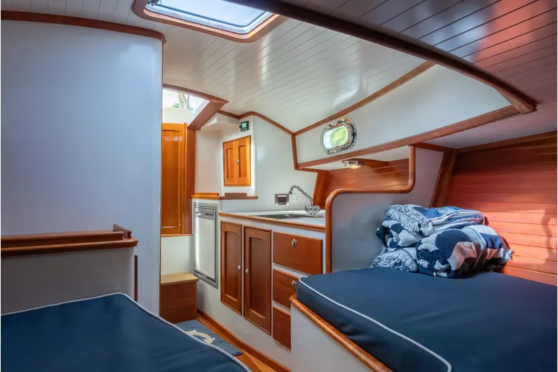 Eloise Yacht Photos Pics 2020 CH Marine Shelter Island Nomad interior with wood cabinetry and cozy sleeping area.
