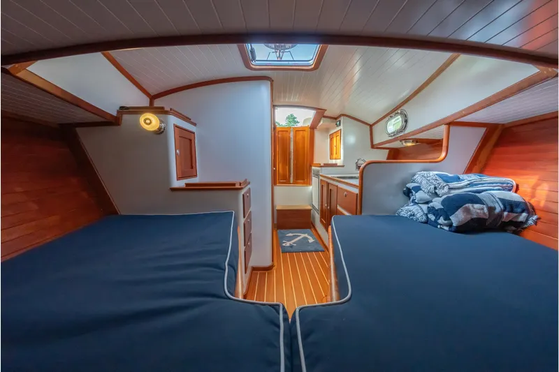 Eloise Yacht Photos Pics Cozy interior of 2020 CH Marine Shelter Island Nomad with twin beds and wooden accents.