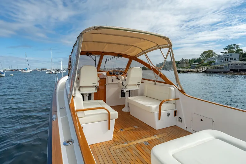 Eloise Yacht Photos Pics 2020 CH Marine Shelter Island Nomad boat with elegant interior, docked in a scenic harbor.