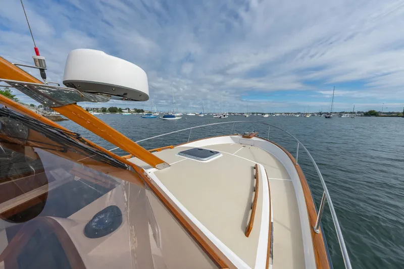 Eloise Yacht Photos Pics 2020 CH Marine Shelter Island Nomad boat on calm waters under a cloudy sky.