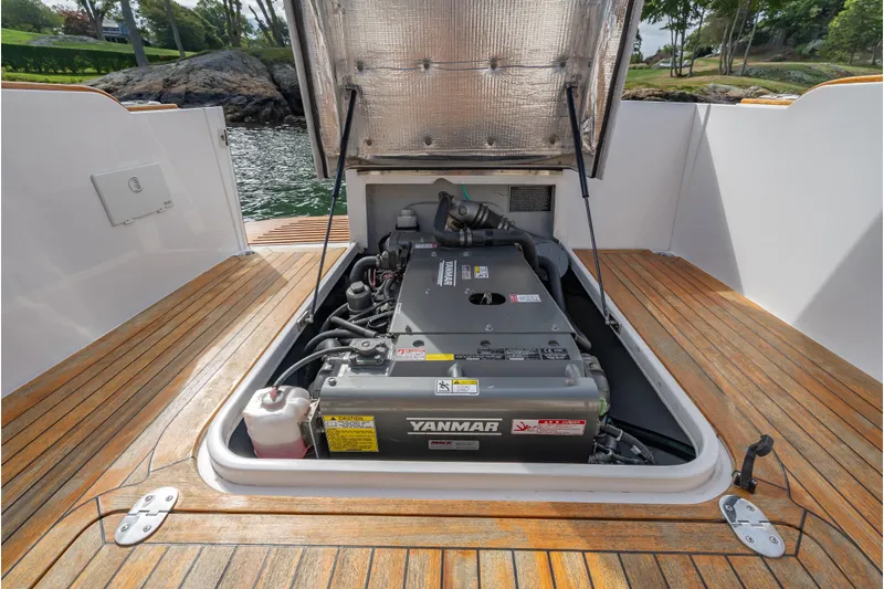 Eloise Yacht Photos Pics 2020 CH Marine Shelter Island Nomad engine compartment with Yanmar engine, open hatch, wooden deck.