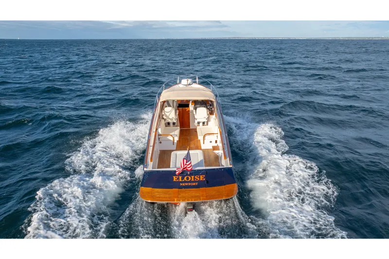 Eloise Yacht Photos Pics 2020 CH Marine Shelter Island Nomad cruising on open sea, rear view with American flag.
