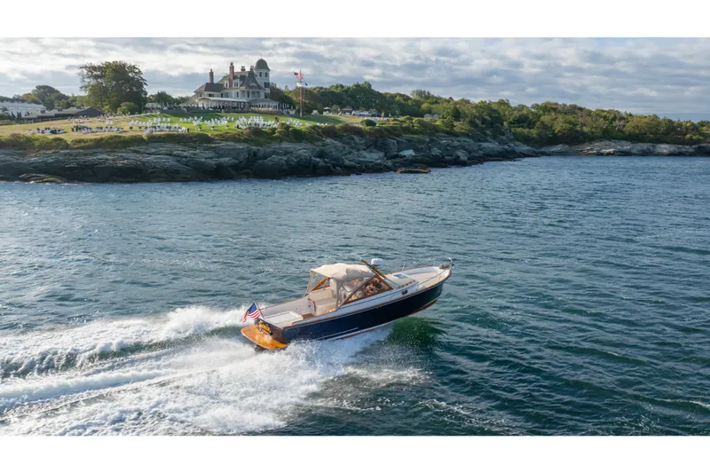 Eloise Yacht Photos Pics 2020 CH Marine Shelter Island Nomad cruising near a scenic coastal estate.