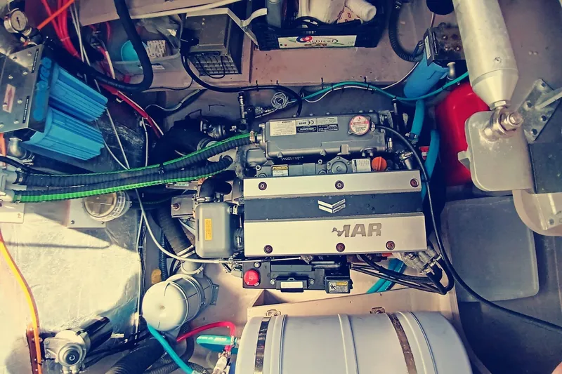  Yacht Photos Pics Engine compartment of a 2021 Bali Catamarans 4.8, showcasing mechanical components and wiring.