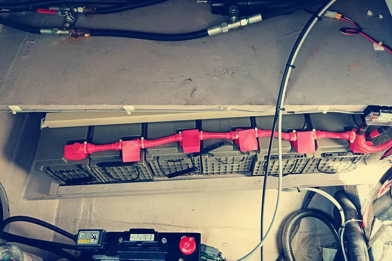  Yacht Photos Pics Battery compartment of a 2021 Bali Catamarans 4.8 with red connectors and cables.