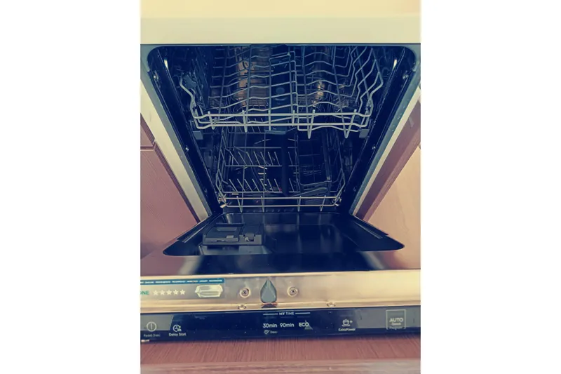  Yacht Photos Pics Open dishwasher inside a 2021 Bali Catamarans 4.8, showcasing racks and control panel.