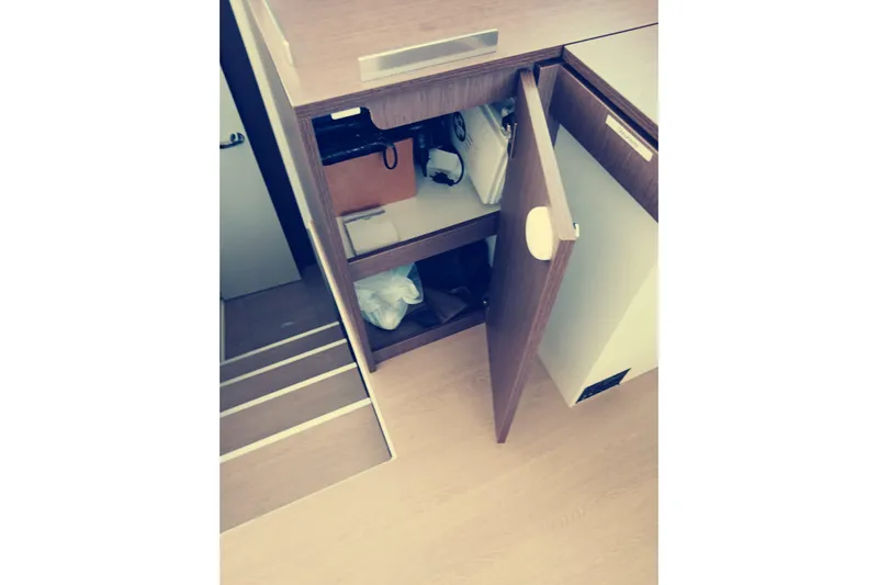  Yacht Photos Pics Interior storage space on a 2021 Bali Catamarans 4.8, featuring open wooden cabinets.