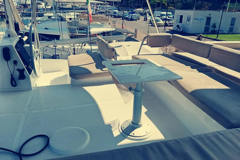  Yacht Photos Pics 2021 Bali Catamarans 4.8 deck with seating and table, docked at marina.