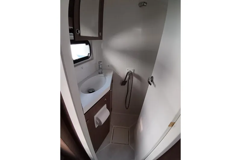  Yacht Photos Pics Compact bathroom in 2021 Bali Catamarans 4.8, featuring sink, shower, and storage.