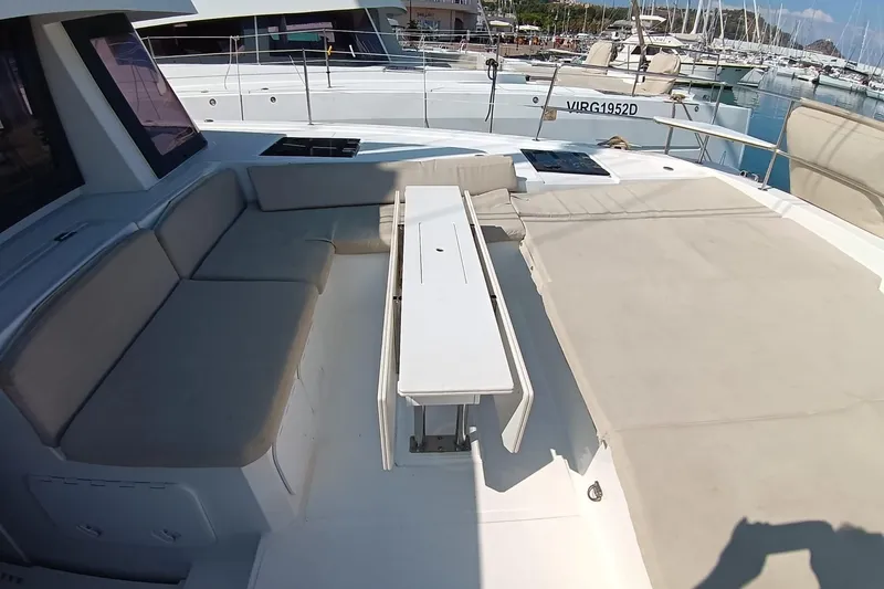  Yacht Photos Pics 2021 Bali Catamarans 4.8 deck with seating and table in marina setting.