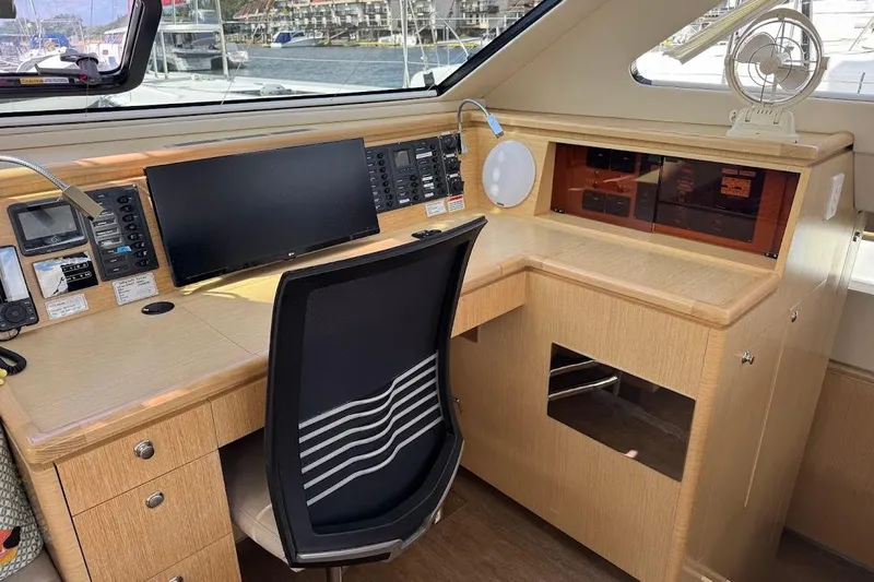 Pure Joy Yacht Photos Pics Modern navigation station on 2023 Seawind 1600 Passagemaker yacht, featuring control panels and seating.