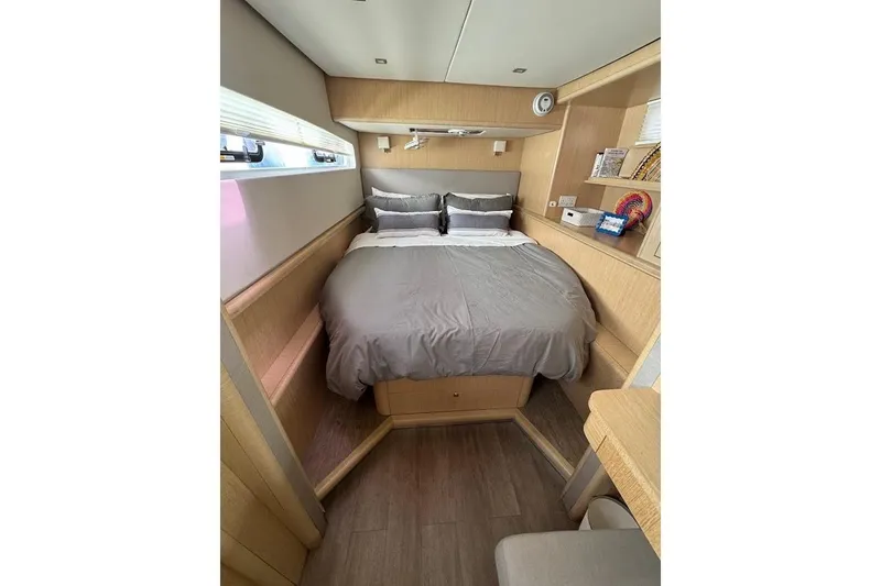 Pure Joy Yacht Photos Pics Luxurious cabin interior of 2023 Seawind 1600 Passagemaker with cozy bed and modern design.