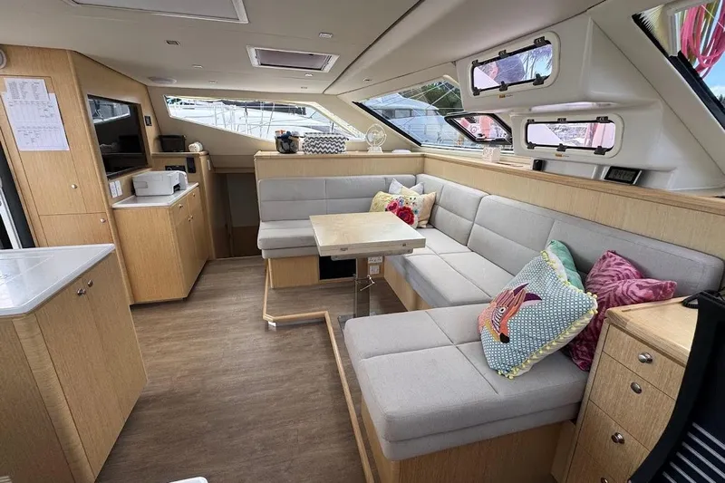 Pure Joy Yacht Photos Pics Luxurious interior of 2023 Seawind 1600 Passagemaker with modern seating and decor.