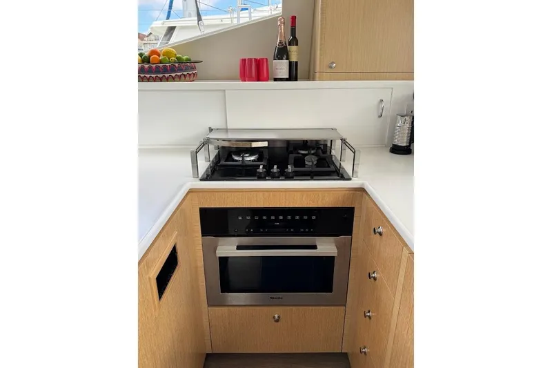 Pure Joy Yacht Photos Pics Modern kitchen in 2023 Seawind 1600 Passagemaker yacht with stove and oven.