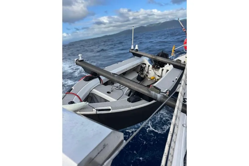 Pure Joy Yacht Photos Pics 2023 Seawind 1600 Passagemaker sailing on open ocean under cloudy skies.