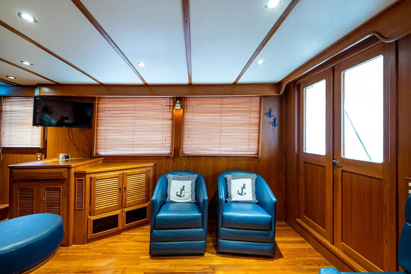 Homes Yacht Photos Pics 2014 DeFever Euro Pilothouse interior with wooden decor and blue seating.