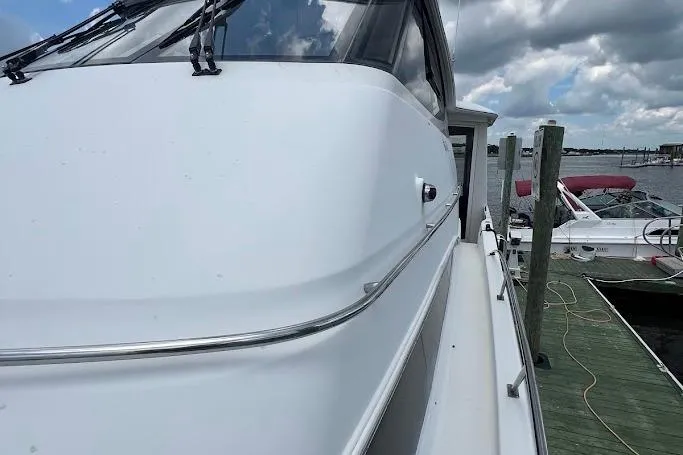 Kiki's Tiki Yacht Photos Pics 2000 Carver 506 Motor Yacht docked, showcasing sleek design and spacious deck.